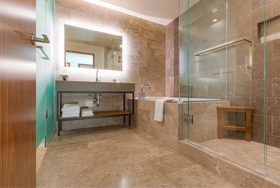 Newly remodeled bathroom with walk-in tile shower completed by One Stop Construction