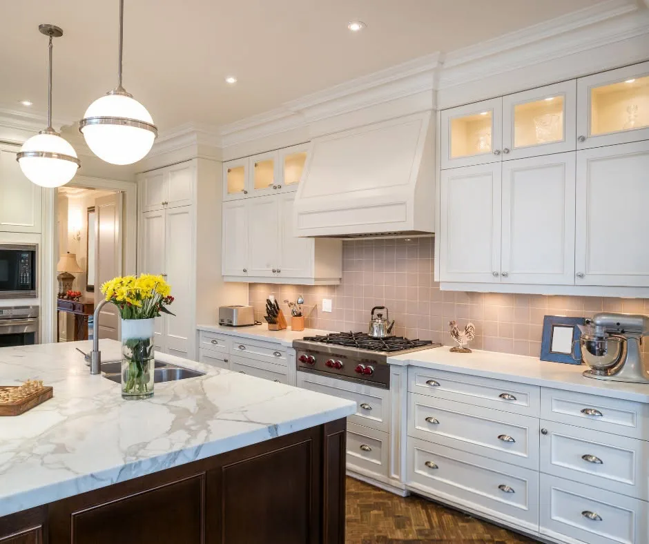 Custom white kitchen with marble counters by One Stop Construction in Southern Utah